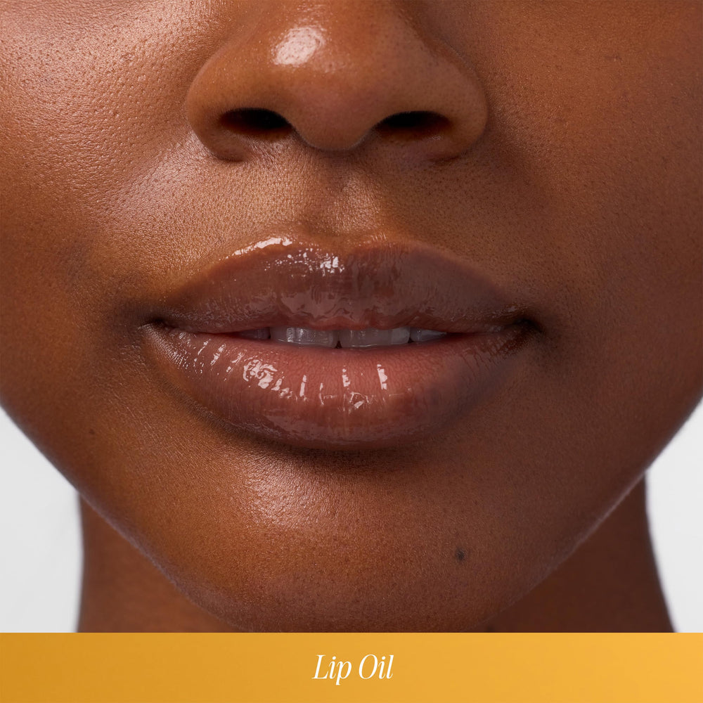 COOLA lip oil in beach setting showing reef-compliant sun protection