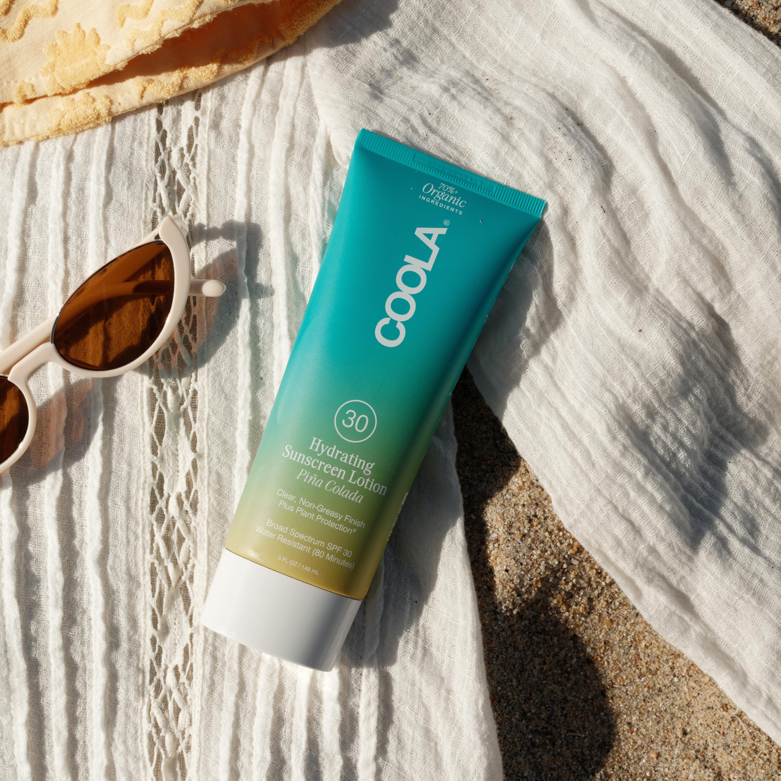 COOLA in a beach setting showing outdoor protection and lifestyle suitability