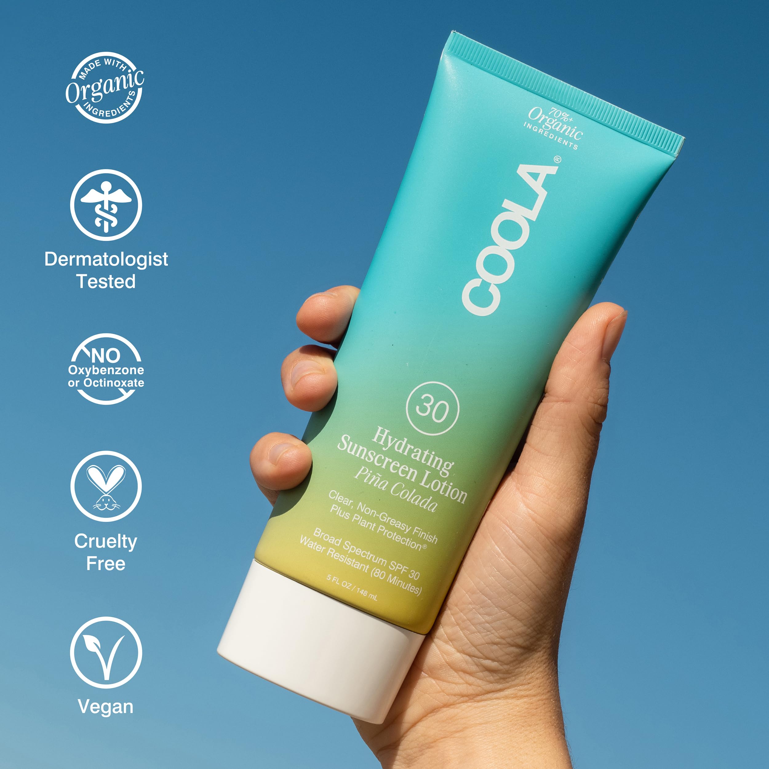 COOLA 5 oz bottle next to a coin for size and portability benefit