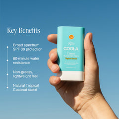 COOLA sunscreen stick in hand to show compact size and easy portability benefit
