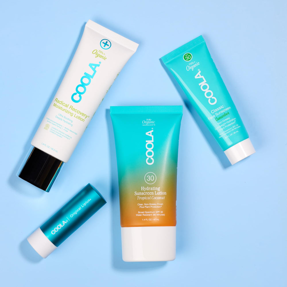 COOLA travel kit beside passport to show airline-friendly sizes
