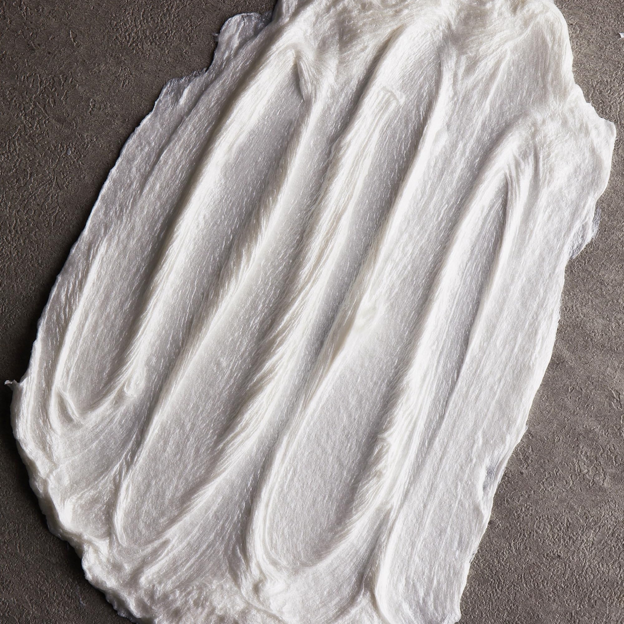 Man applying Cremo shave cream providing smooth, comfortable shave