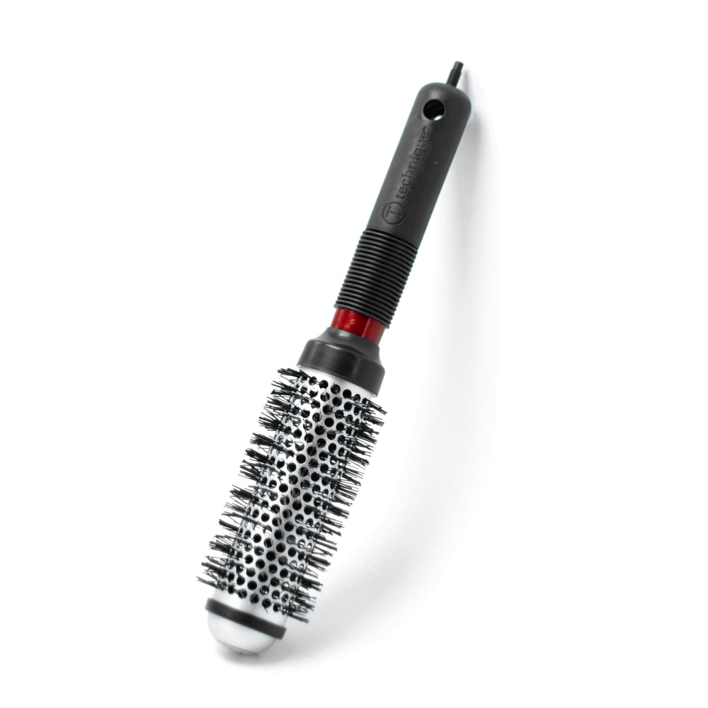 Cricket brush in use with blow dryer creating voluminous, salon-quality results