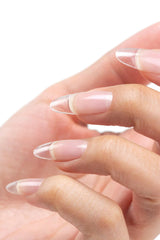 Technician applying Cuccio Pro builder gel in salon for durable nail enhancements