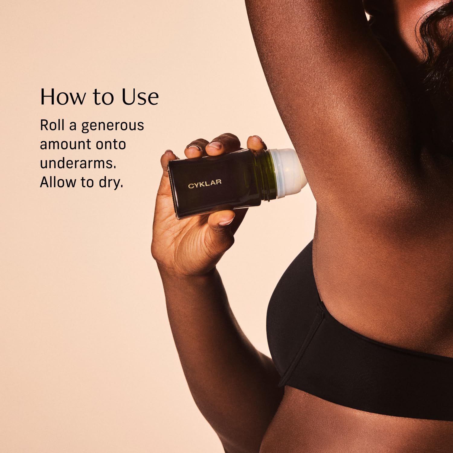 CYKLAR bottle next to hand to show size and travel-friendly benefit