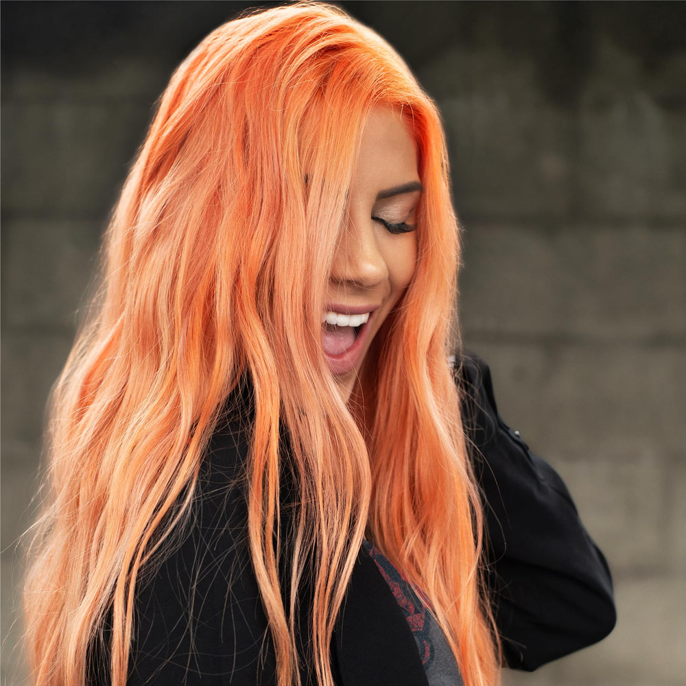 Danger Jones on vanity with styled light peach hair illustrating wearable pastel look