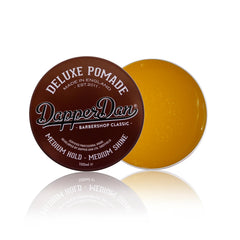 Model with slick-back hairstyle styled using Dapper Dan for polished medium shine finish