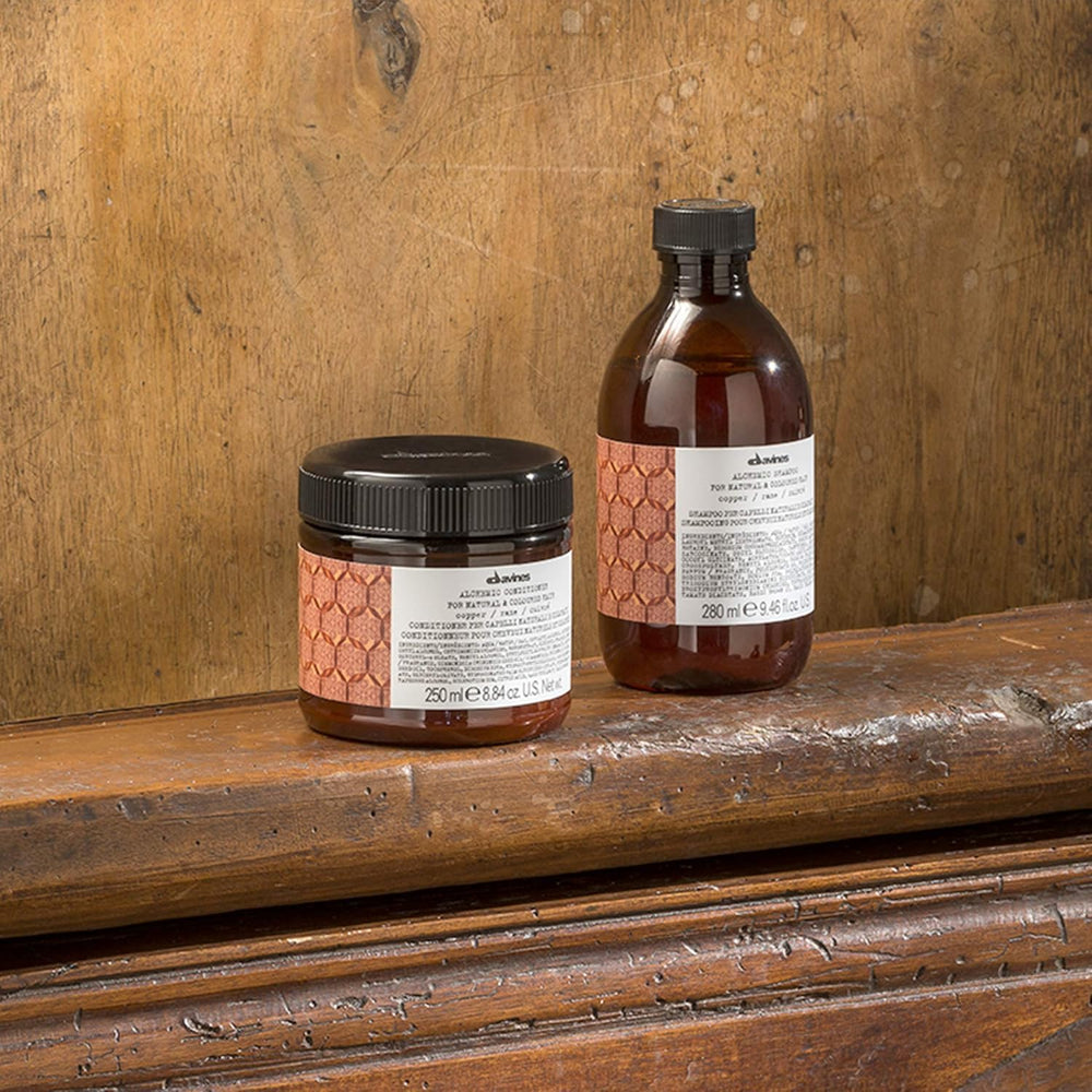 Davines before and after hair strand showing enhanced copper tone benefit