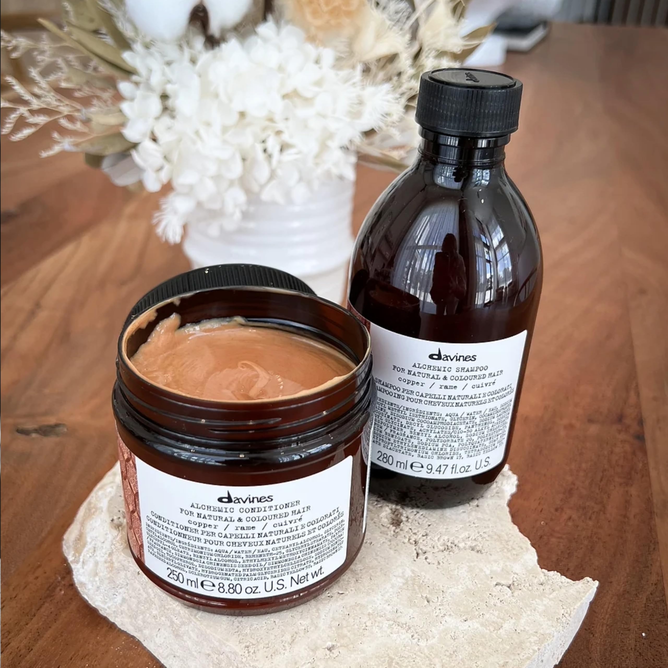 Davines 250ml bottle beside a coin for scale and travel-friendly size benefit