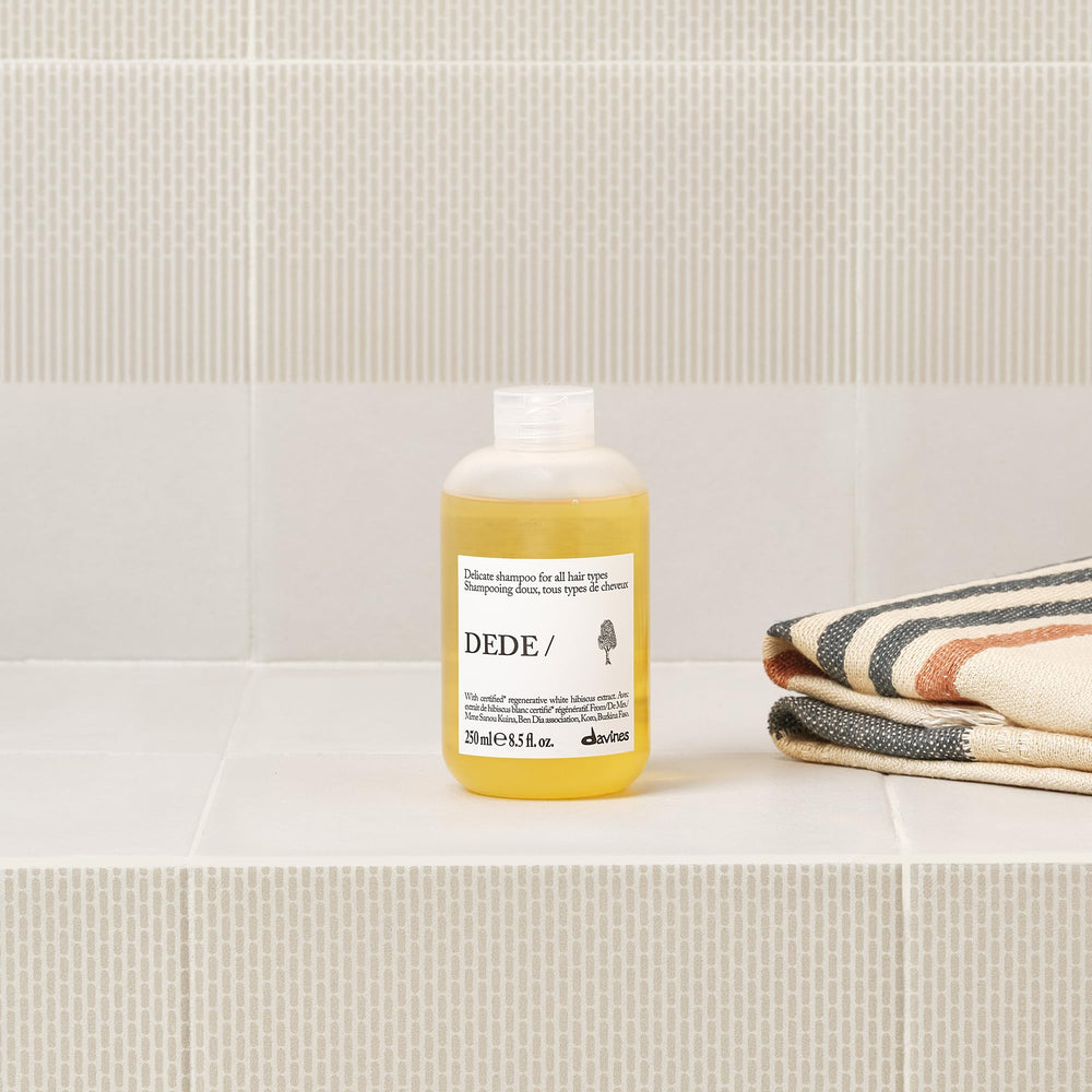 Davines DEDE shampoo pouring into hand for easy application benefit