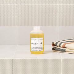 Davines DEDE shampoo pouring into hand for easy application benefit
