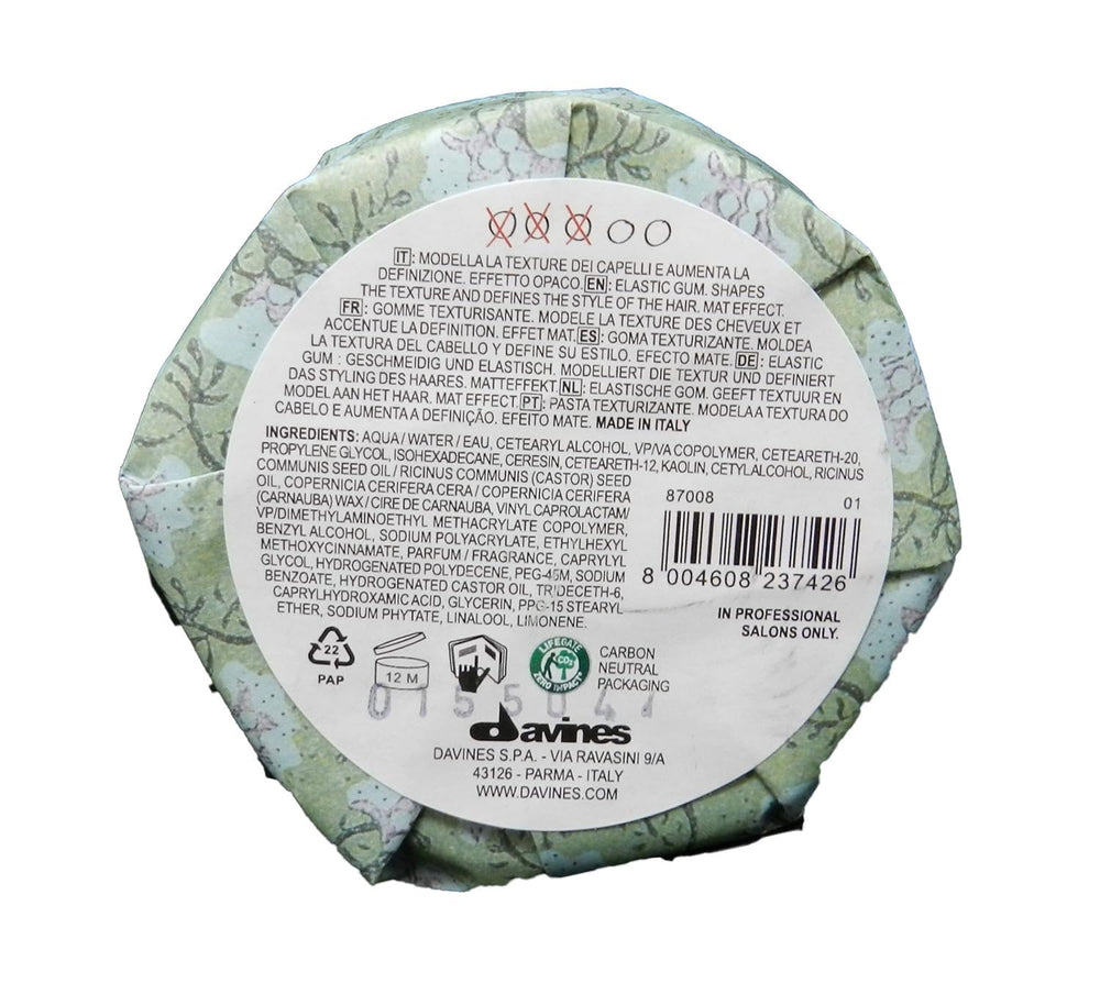 Davines finishing gum next to recyclable packaging emphasizing sustainable choice