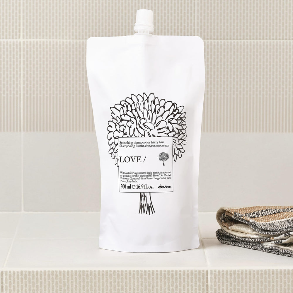 Davines refill being poured into bottle demonstrating easy refill benefit