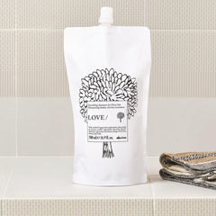Davines refill being poured into bottle demonstrating easy refill benefit