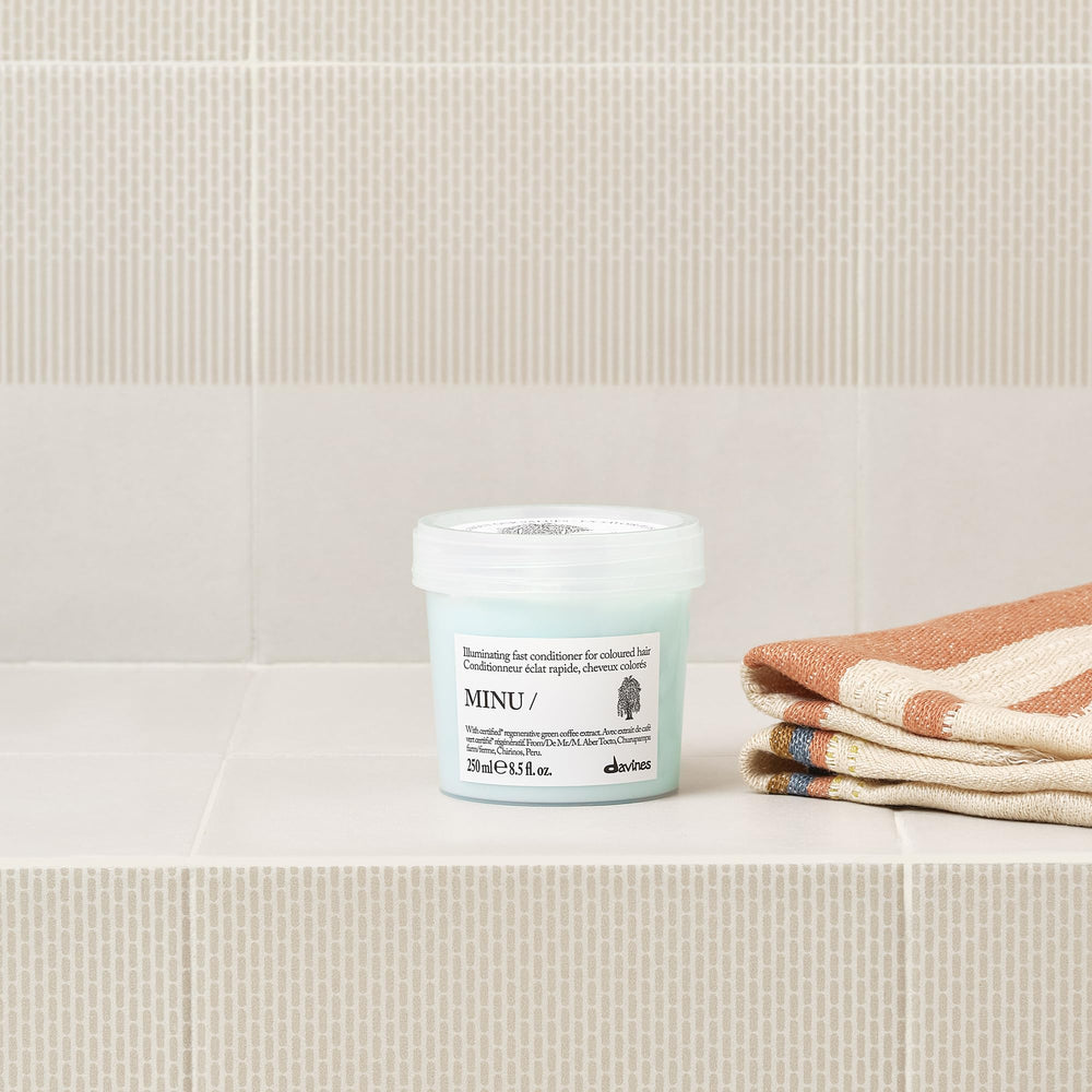 Davines conditioner being applied to wet hair for easier detangling