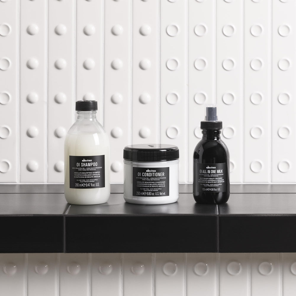 Hand holding Davines bottle for scale and easy daily use benefit