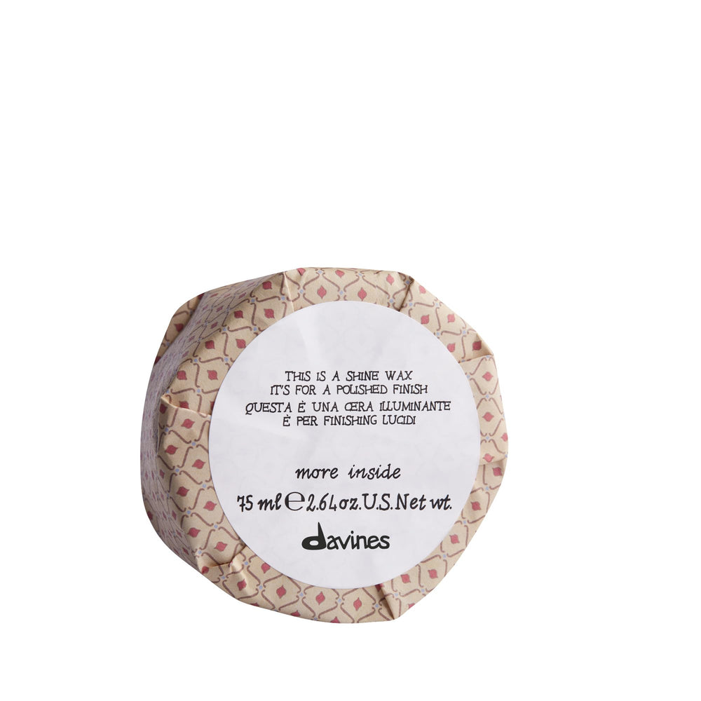 Davines stylist using wax to perfect an up-do showing professional use