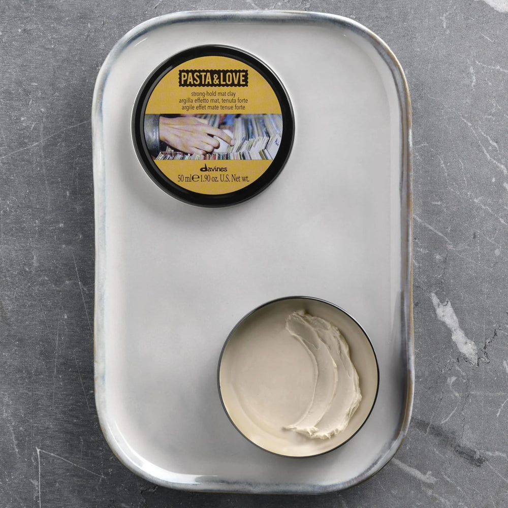 Davines jar next to coin for scale to show compact, travel-friendly size