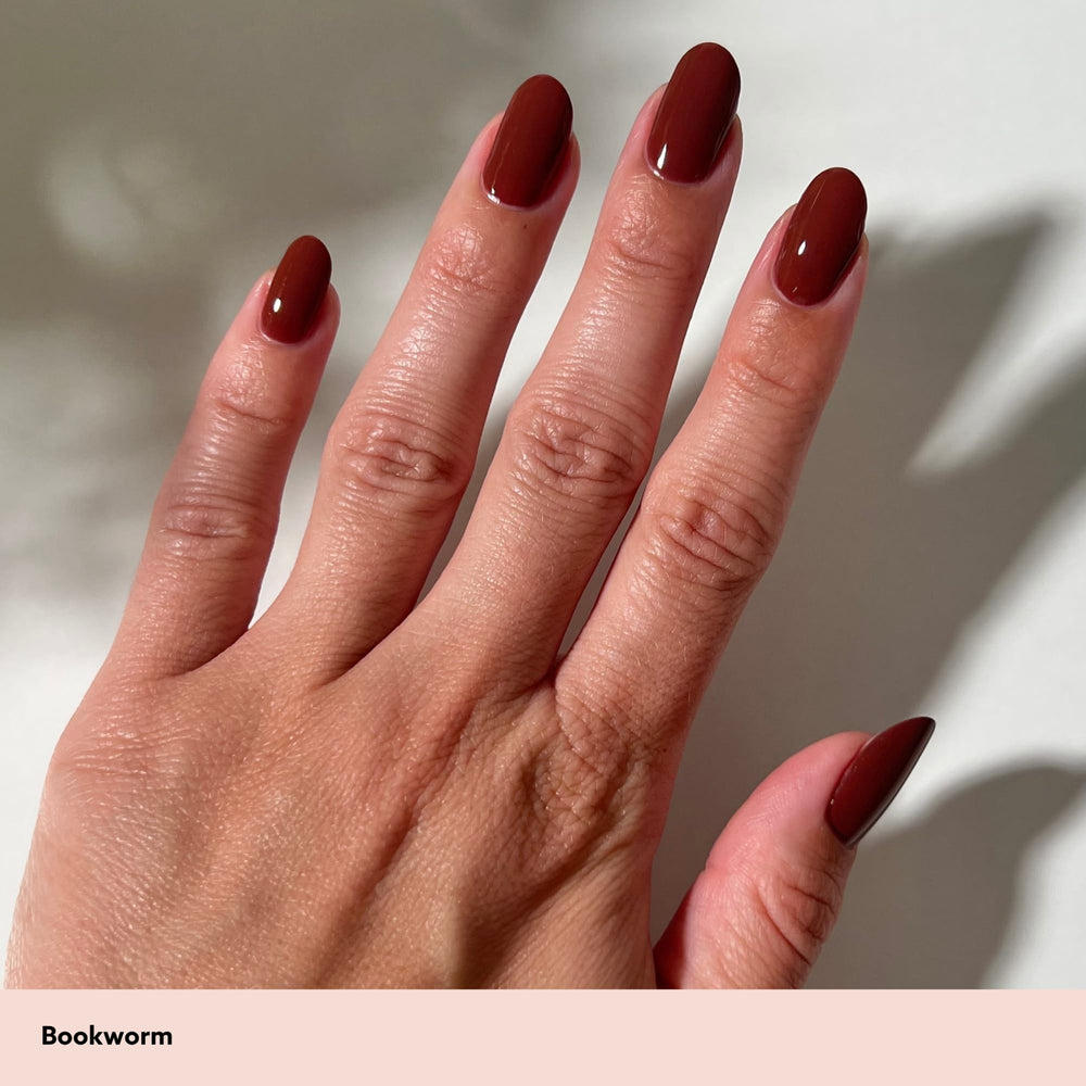 Dazzle Dry manicure in use with Bookworm on nails, showing salon-quality wear benefit