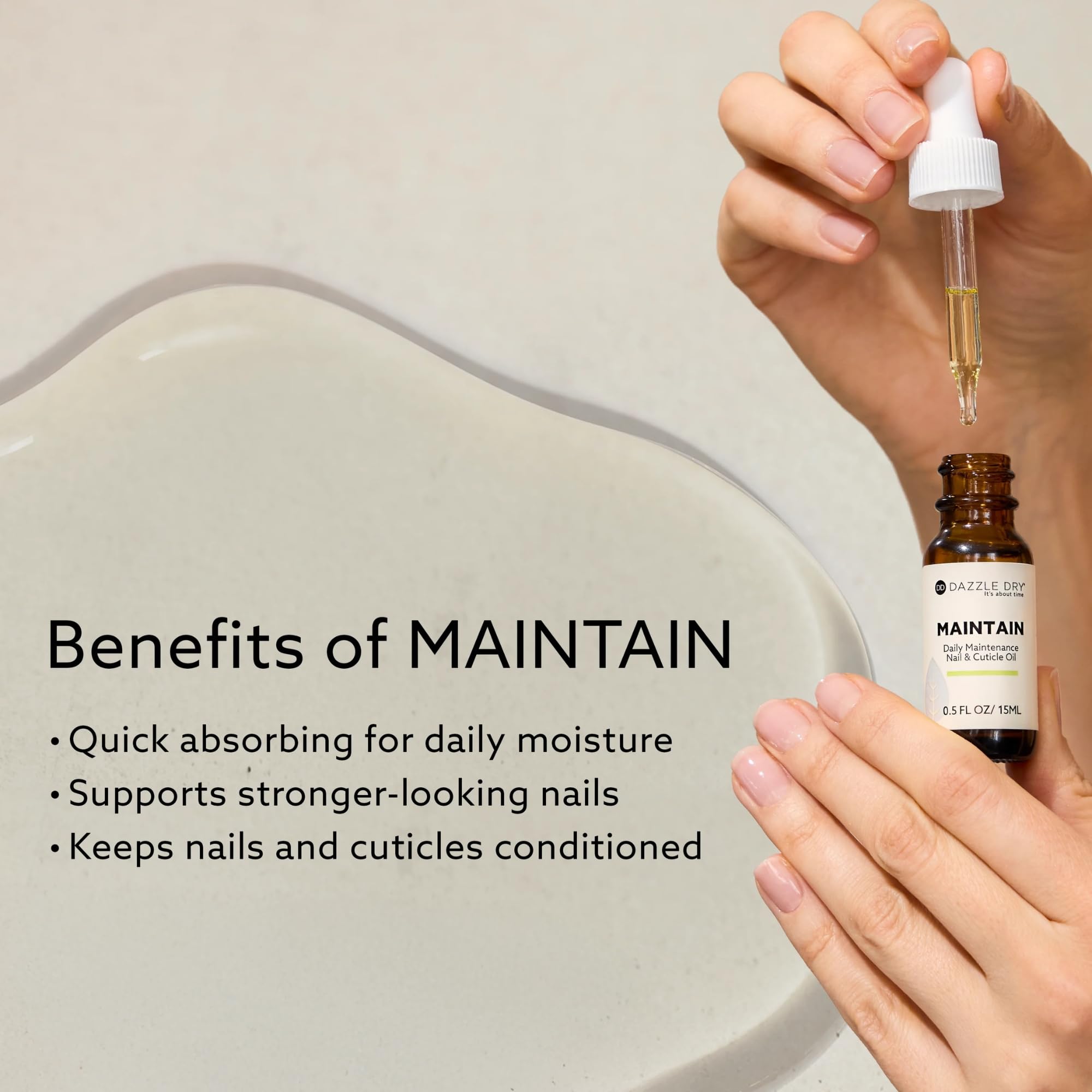 Hand applying Dazzle Dry oil to cuticles, demonstrates smoother nails benefit