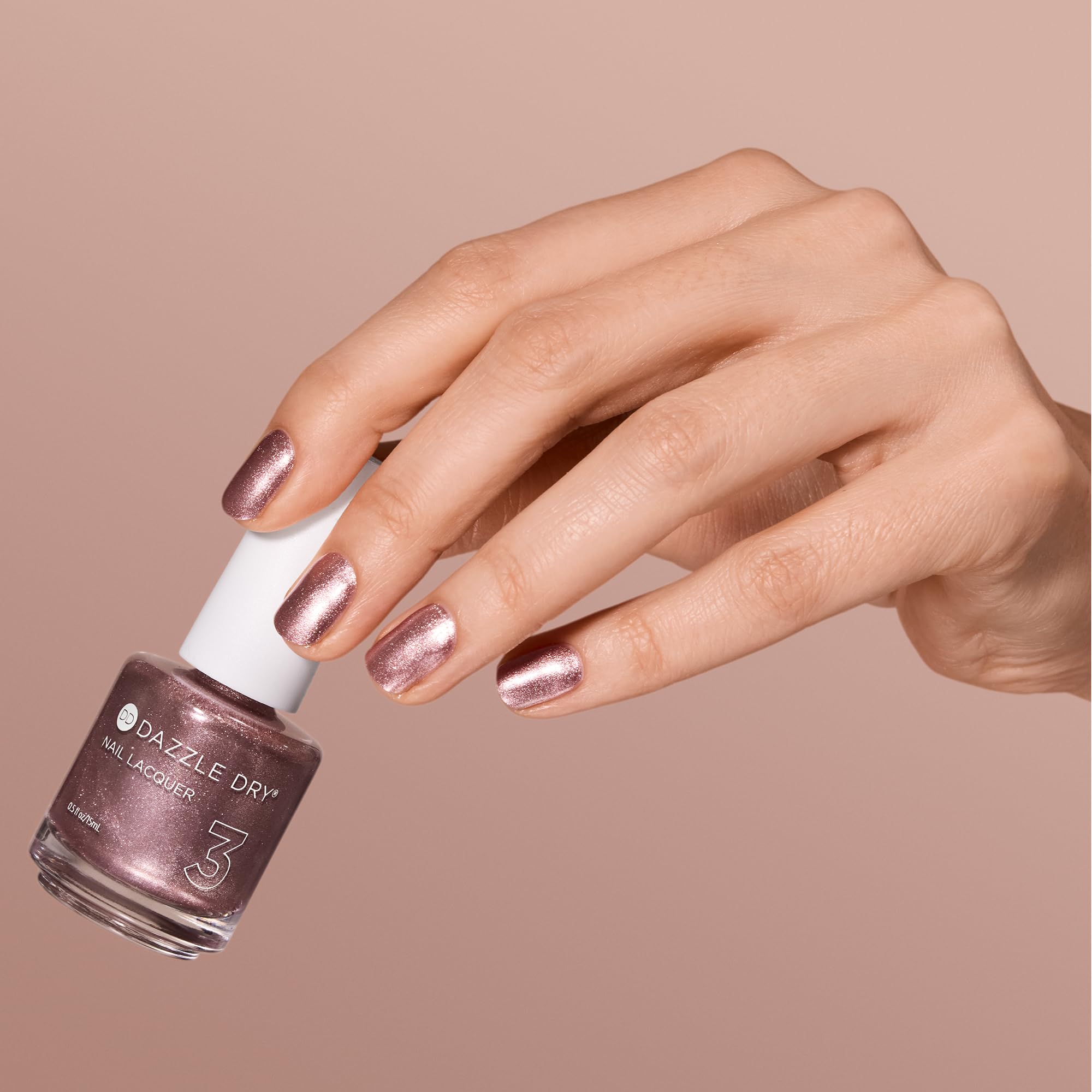 Dazzle Dry Out N' About swatch on nail wheel demonstrating full-coverage metallic payoff