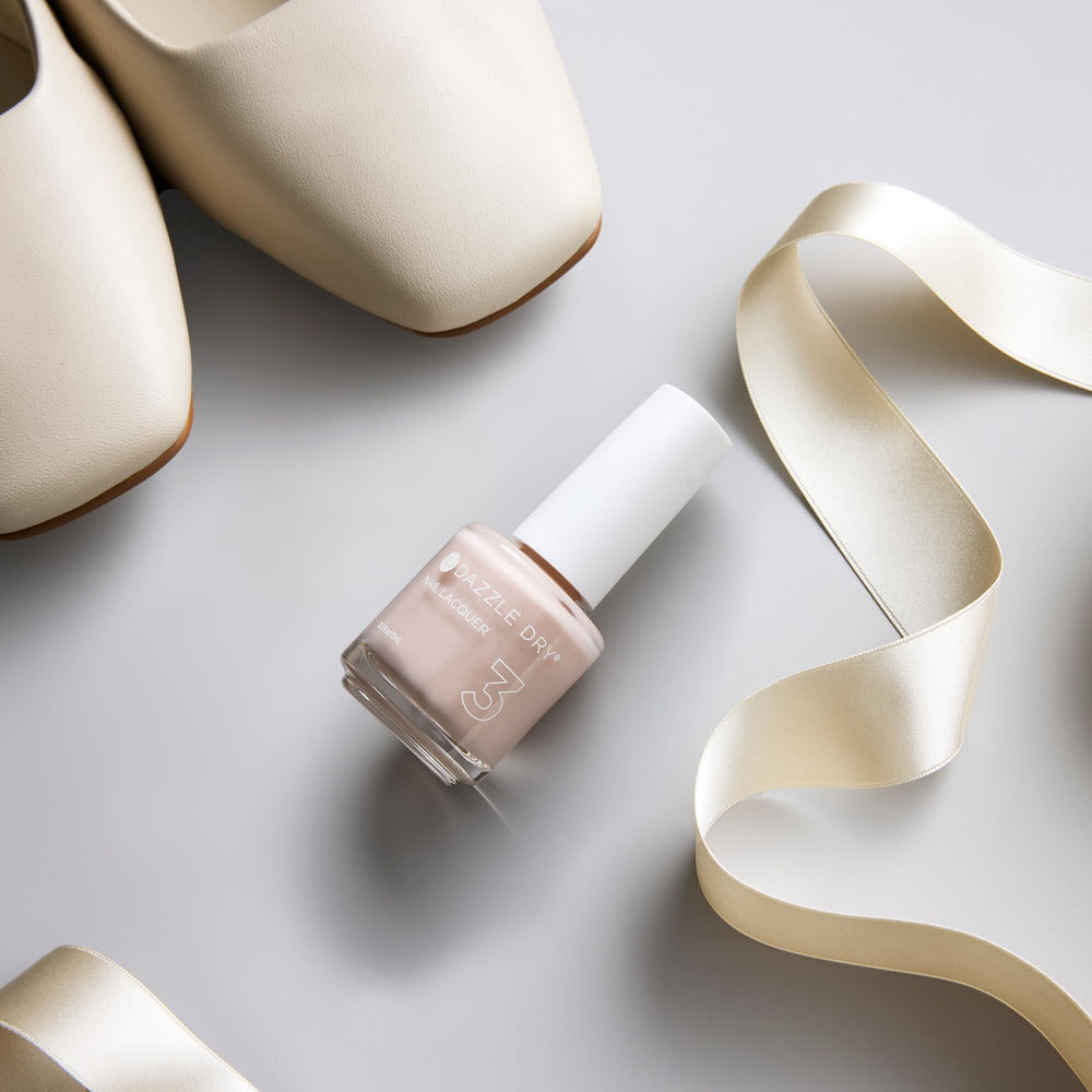 Dazzle Dry bottle on bathroom vanity suggesting easy at-home salon results