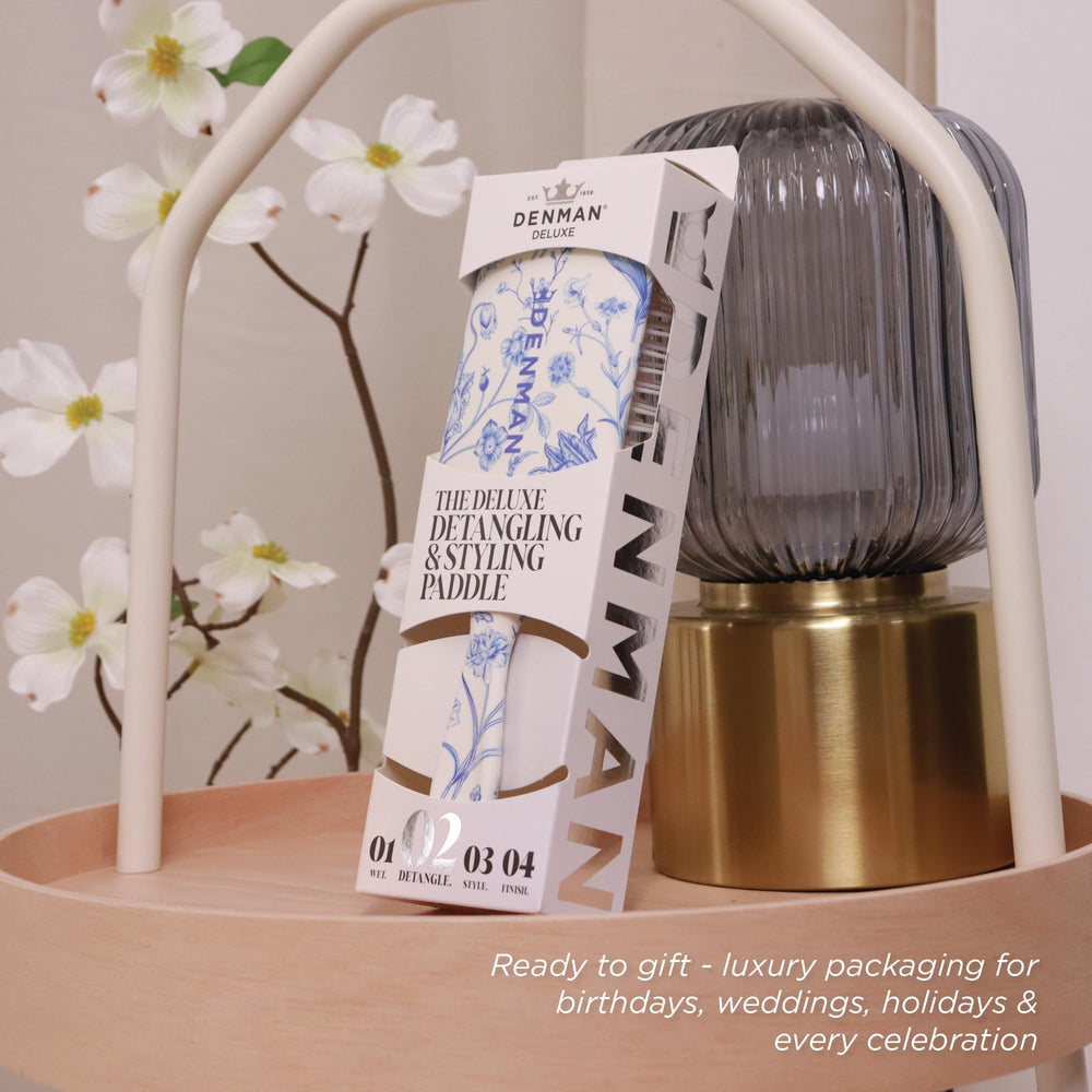 Denman paddle brushing wet hair to reduce knots and breakage