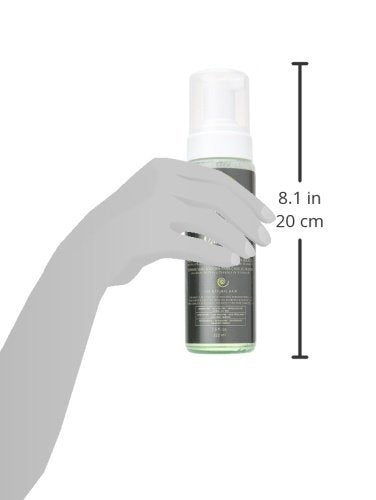 Design Essentials 7.5 oz bottle in hand demonstrating portable size and travel ease