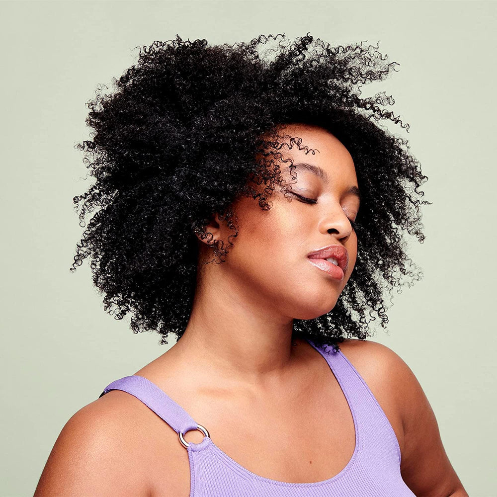 DevaCurl cream texture close-up showing smooth consistency that aids detangling benefit
