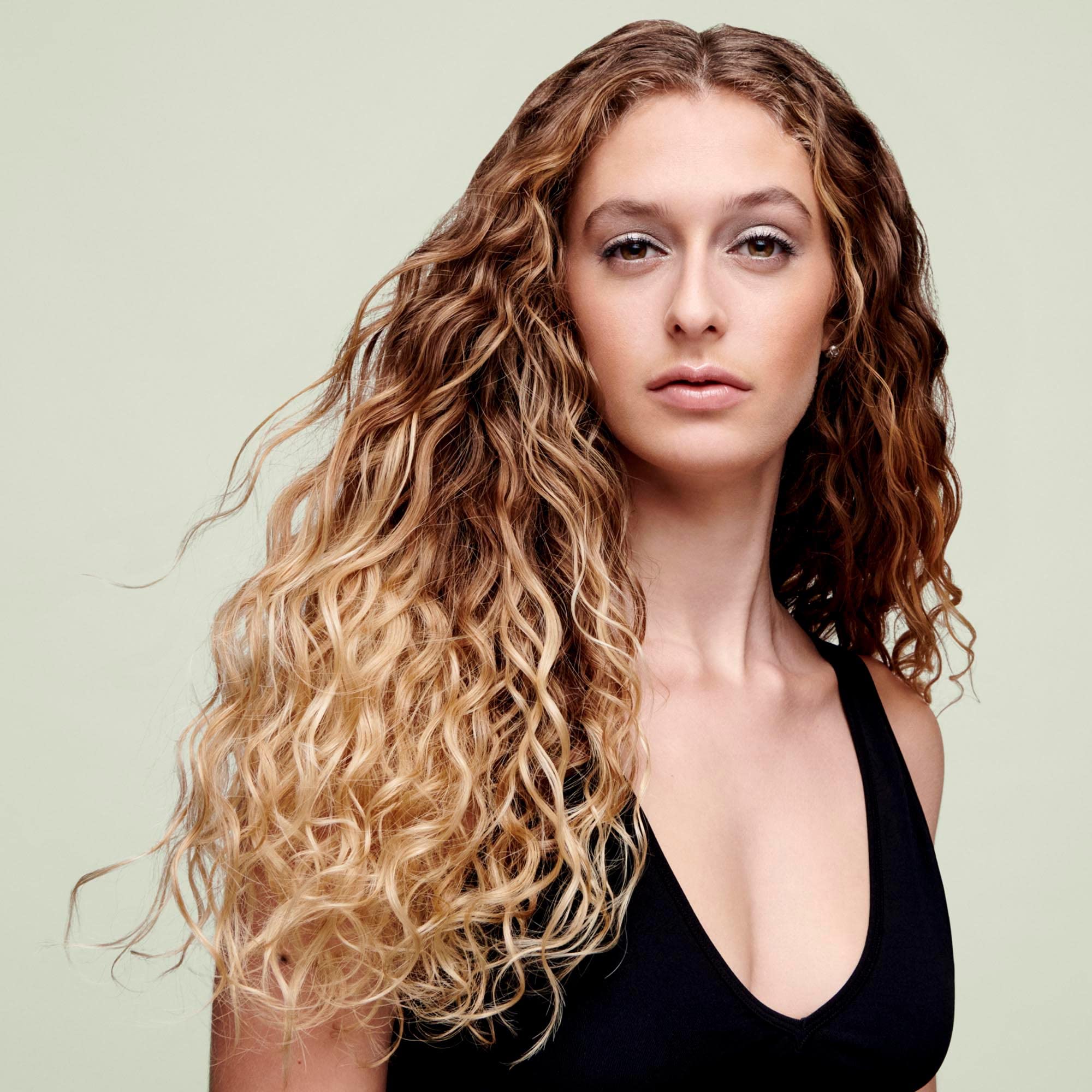 DevaCurl being lathered in hand, showing gentle foam and effective cleansing