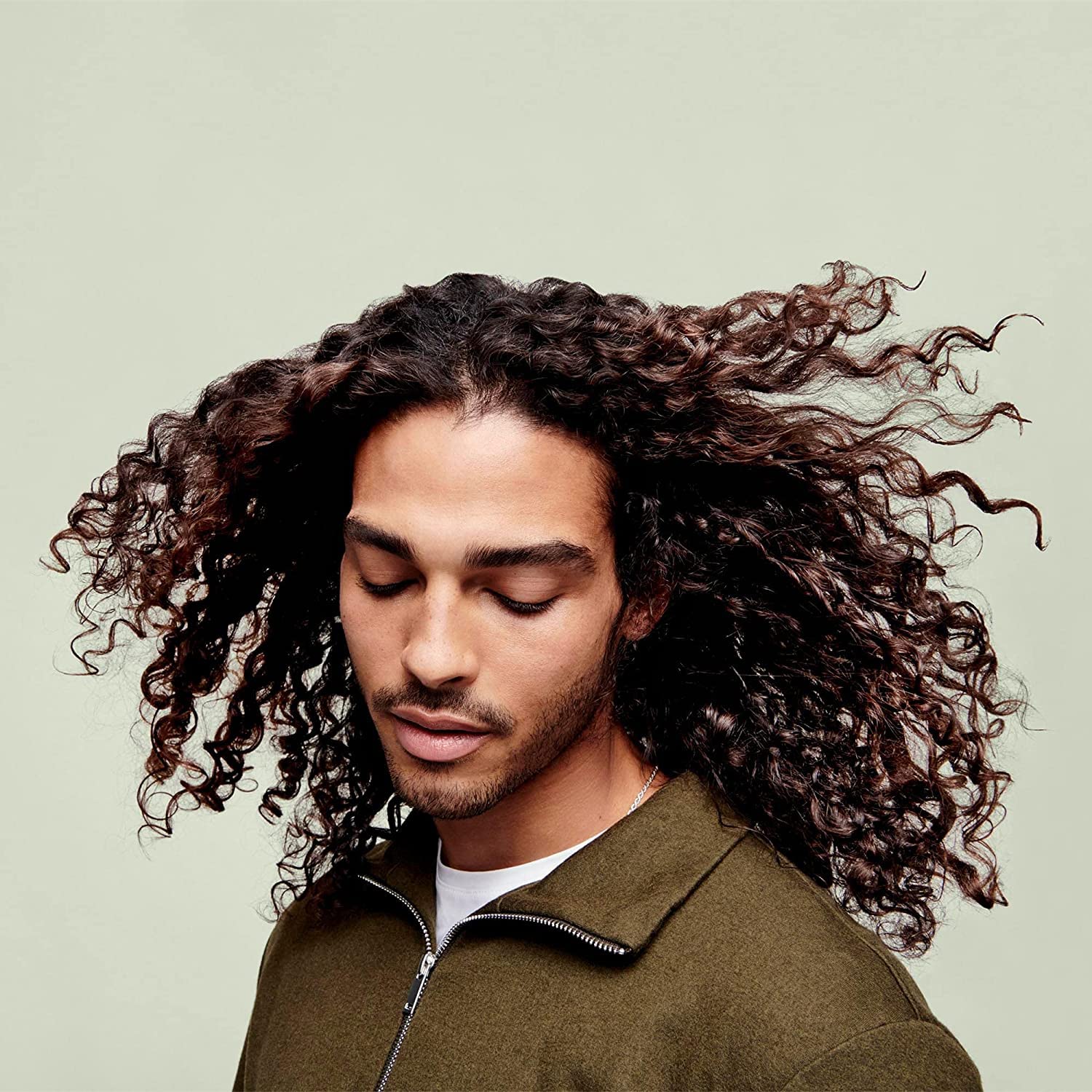 DevaCurl 12 fl oz bottle beside hand showing true product scale