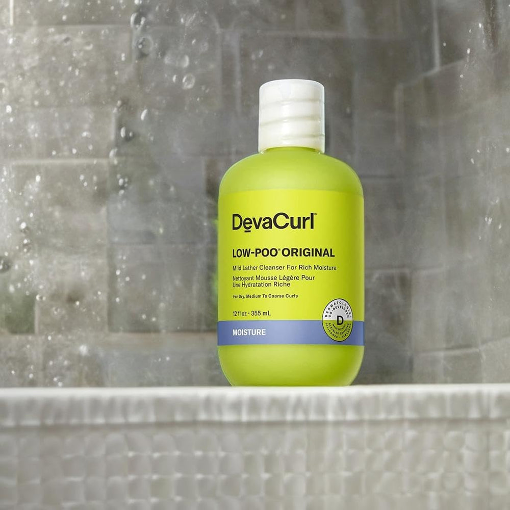 DevaCurl 12 fl oz bottle next to hand for size comparison and portability benefit