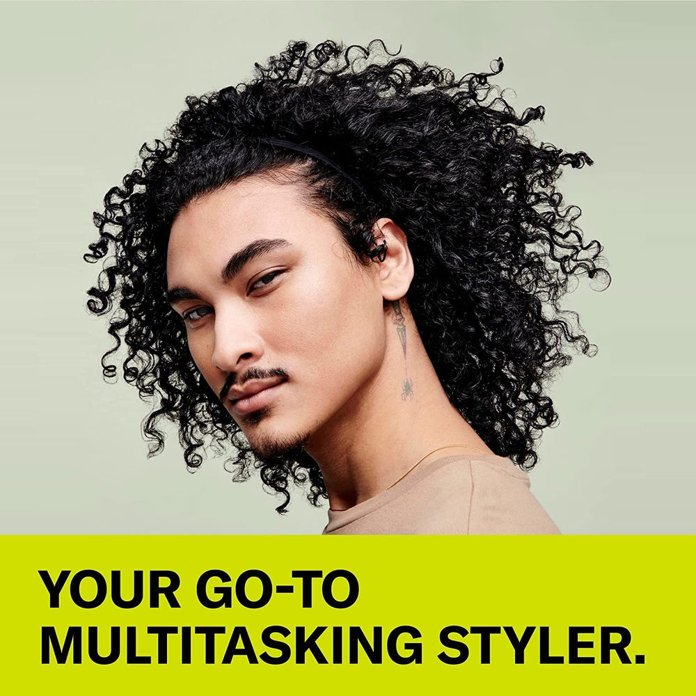 Hand applying DevaCurl SuperCream to damp curls demonstrating easier styling and definition