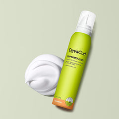 DevaCurl SuperMousse mousse texture on hand demonstrating creamy, buttery feel