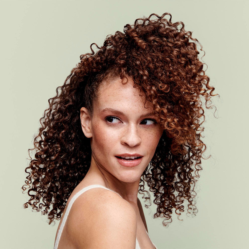 DevaCurl creamy texture close-up demonstrating moisturizing consistency benefit