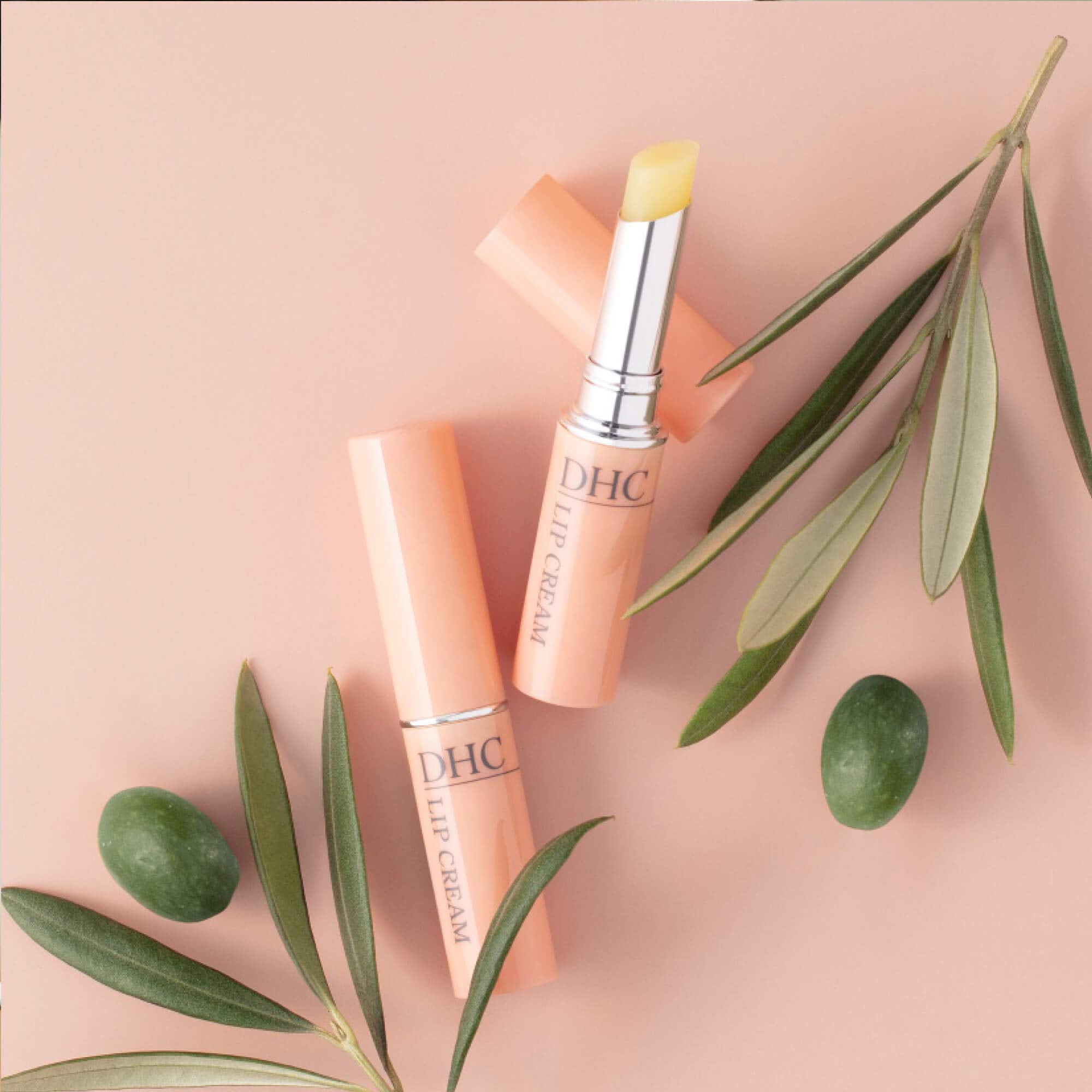 DHC lip cream texture on finger demonstrating creamy spreadable hydration