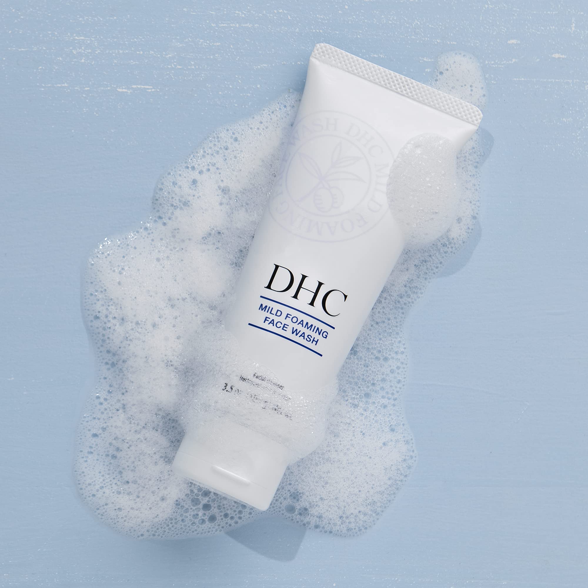 DHC tube held in hand showing 3.5 oz scale for accurate size expectation