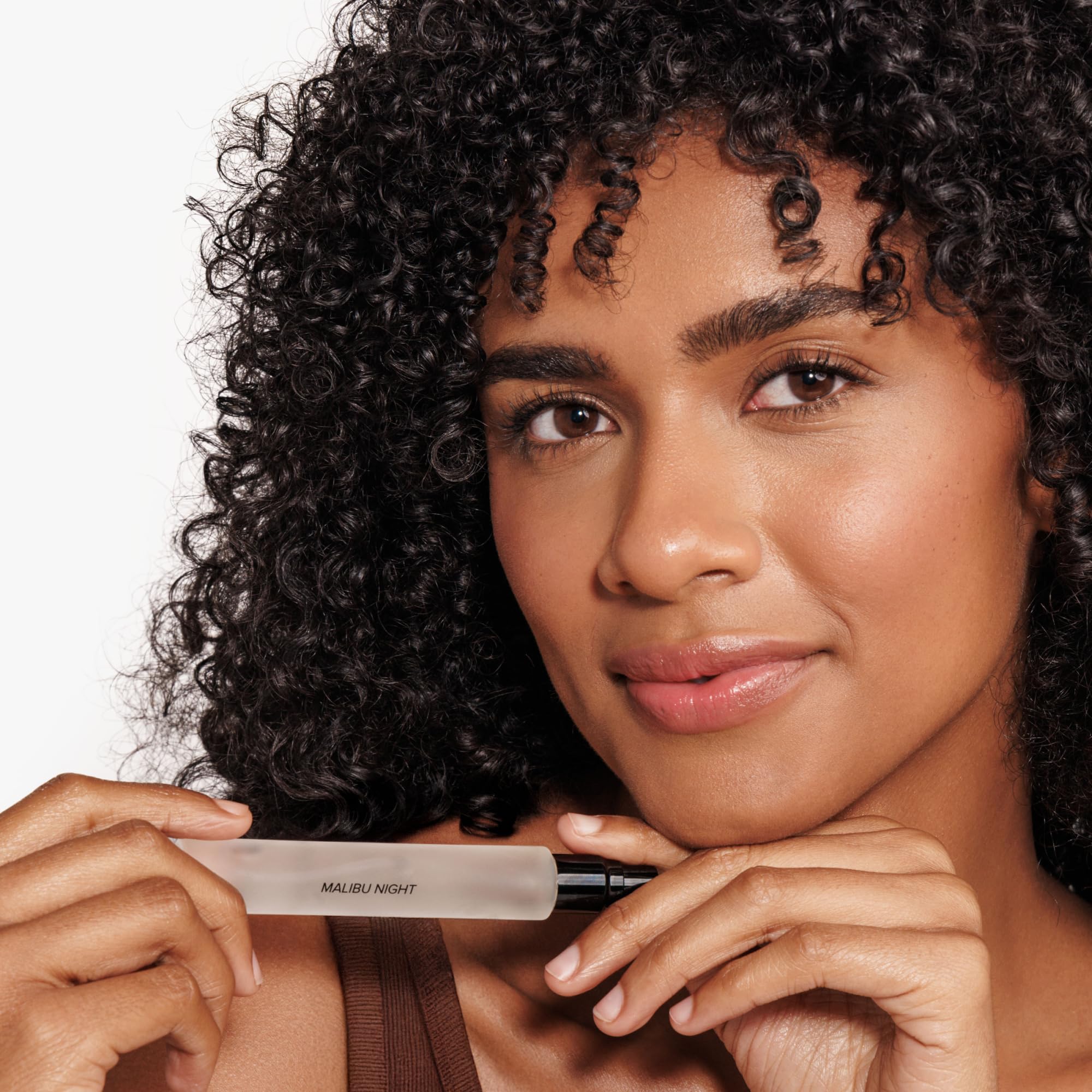 DIME Malibu Night spray in hand demonstrating purse-ready portability and easy reapplication