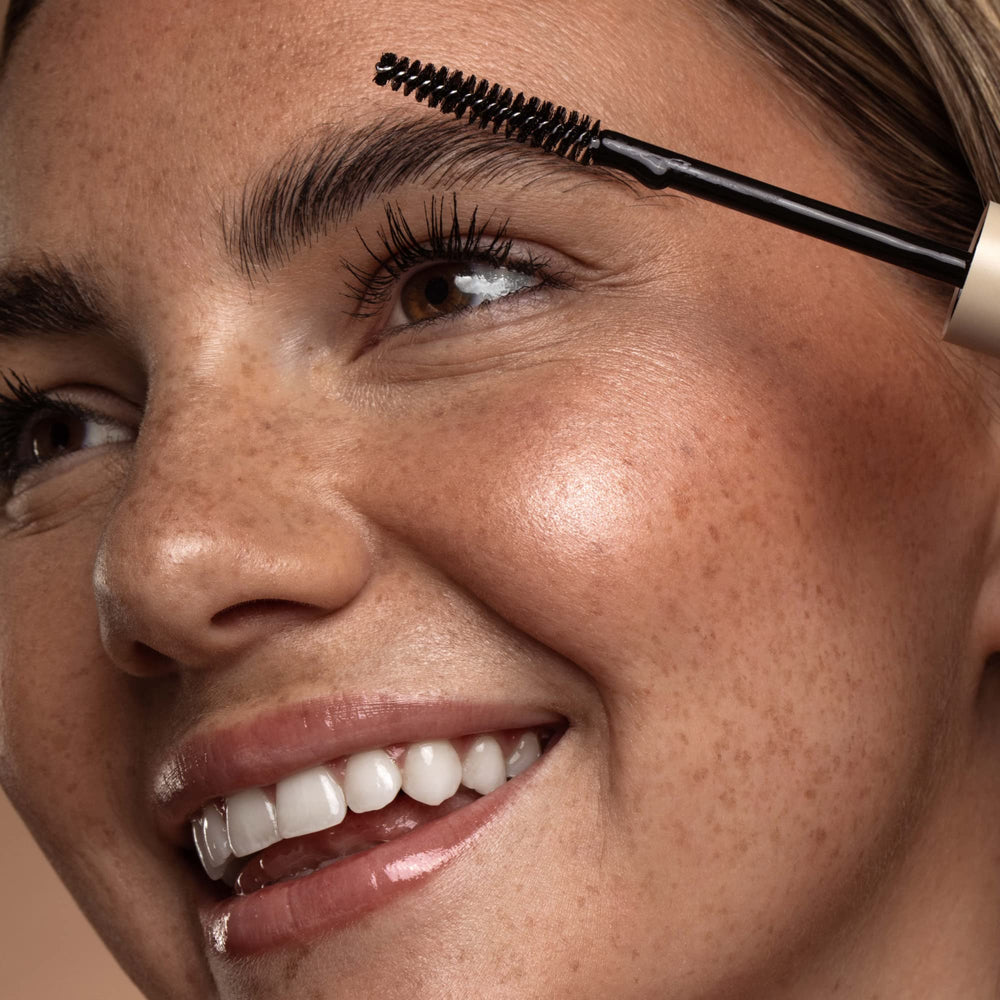 DIME wand in hand showing applicator size for targeted brow shaping