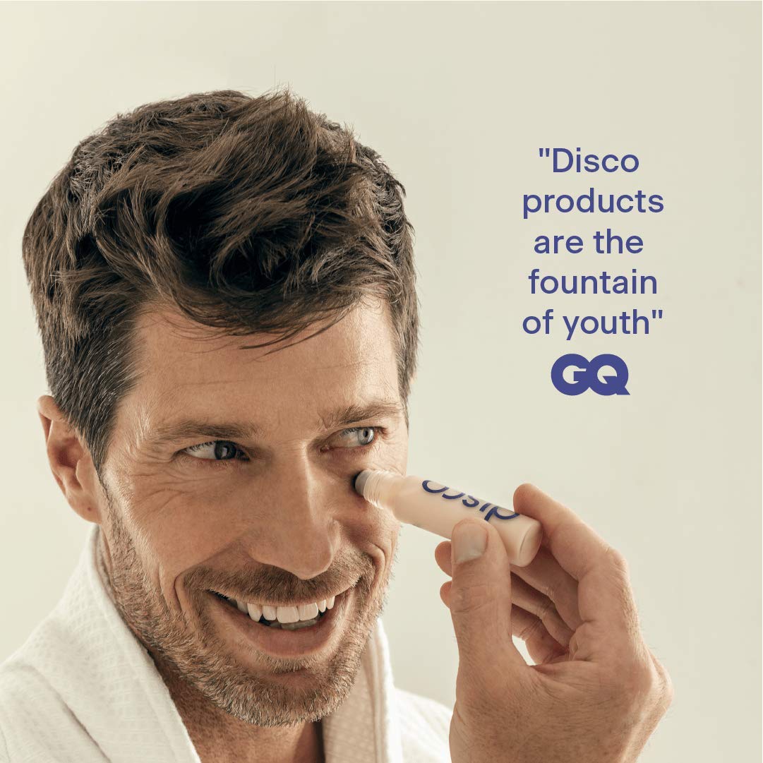 Disco 10mL size beside a coin to show compact travel-friendly volume