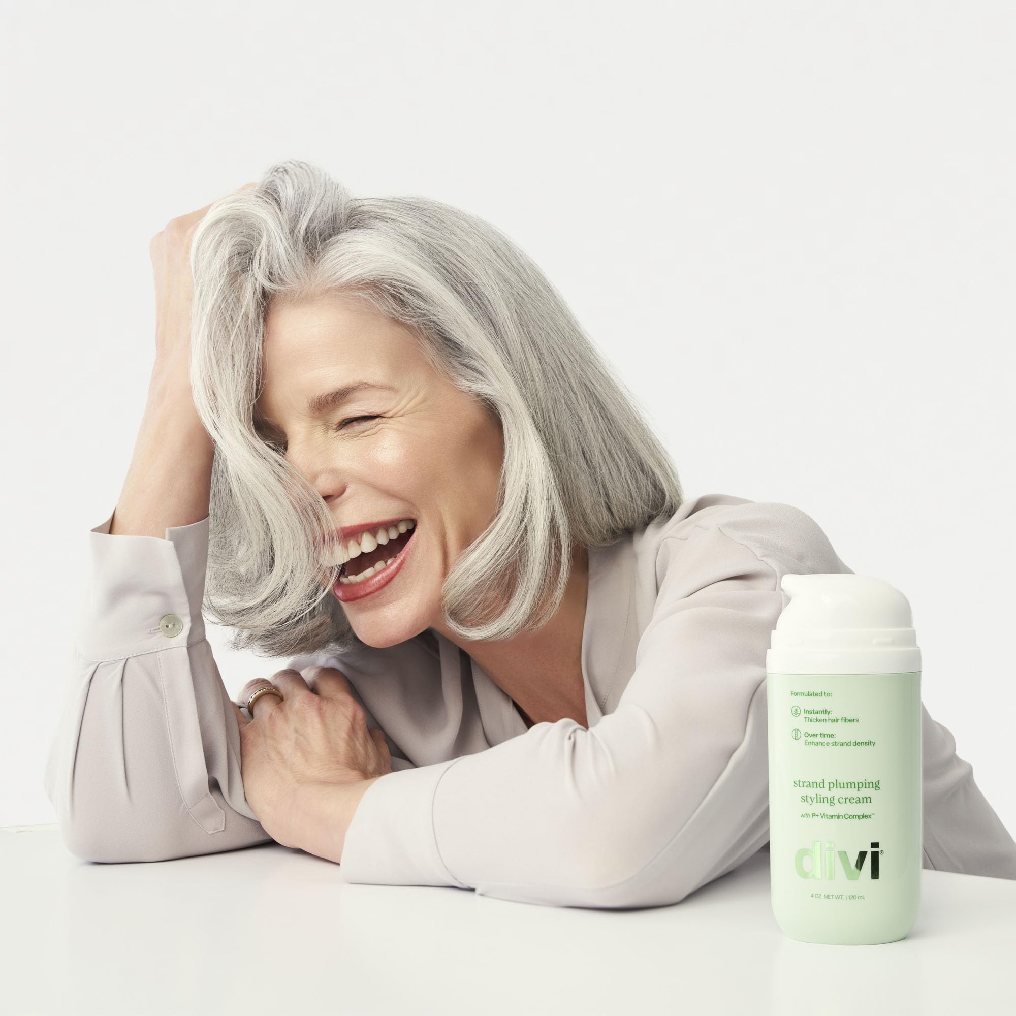 divi 4 oz tube in hand to show actual size and travel-friendly benefit
