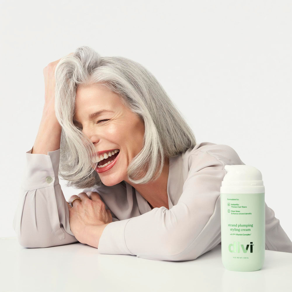 divi 4 oz tube in hand to show actual size and travel-friendly benefit