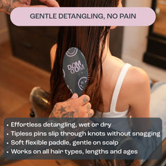 Dom Dom detangler side profile highlighting flexible paddle for gentle scalp pressure distribution