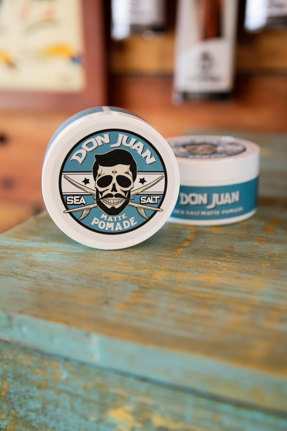 Don Juan pomade on bathroom counter near surfboard for lifestyle vibe