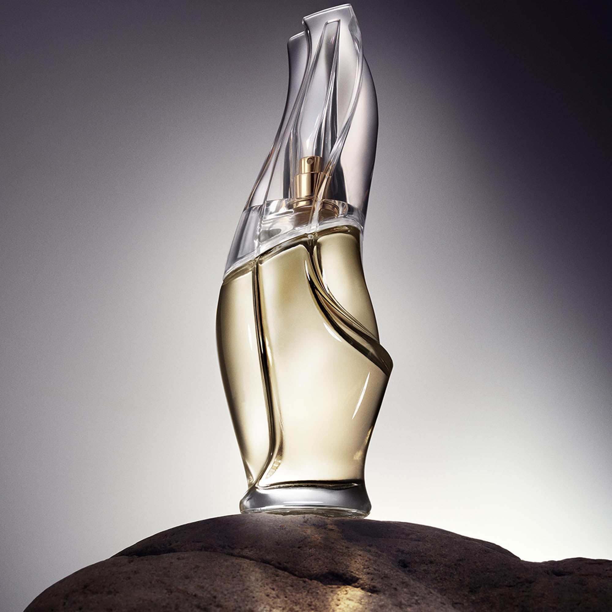 Donna Karan Cashmere Mist being sprayed from hand for on-the-go refresh