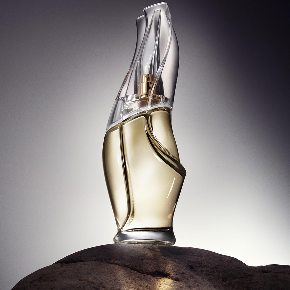 Donna Karan Cashmere Mist being sprayed from hand for on-the-go refresh