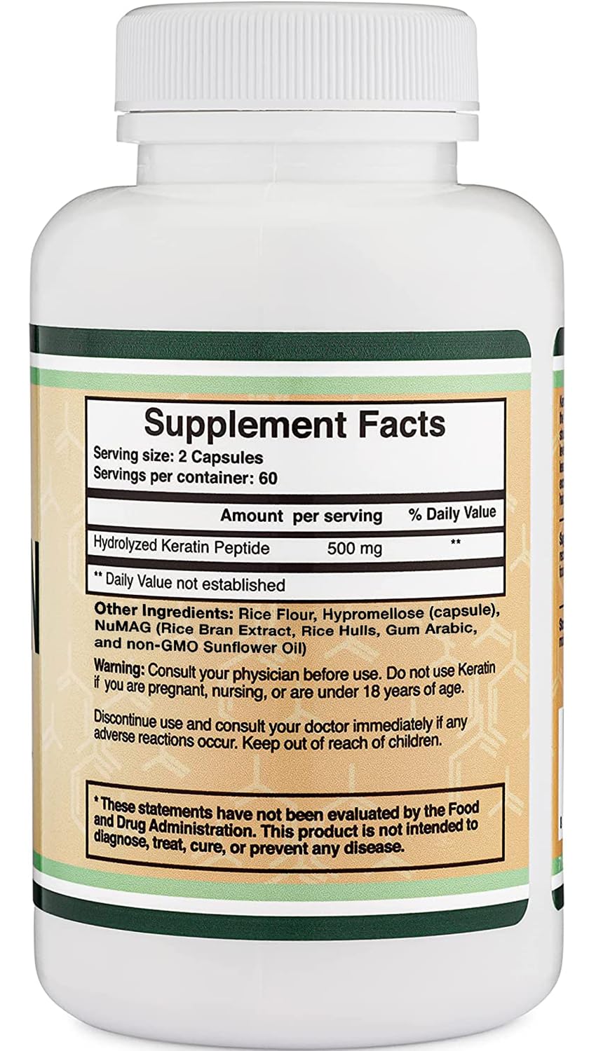 Hand holding several Double Wood keratin capsules demonstrating serving size and ease