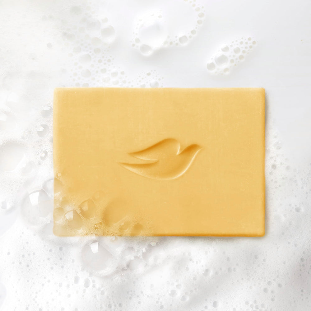Dove unwrapped bar surface detail showing smooth moisturizer finish