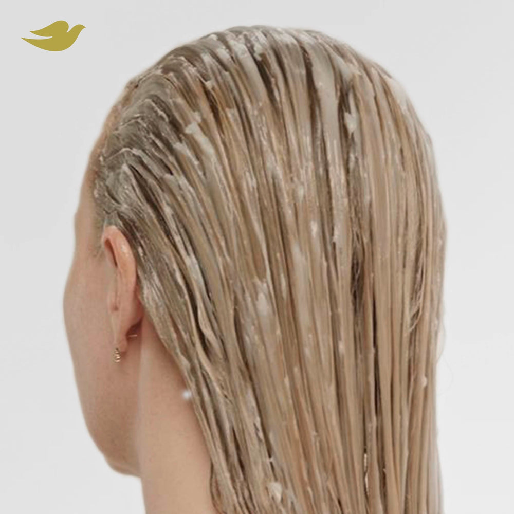 Dove serum applied to dry hair lengths improving shine and reducing frizz