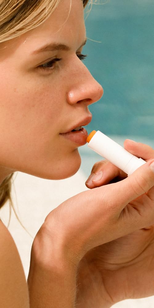 Dr. Hauschka lip care stick held in hand to show size and easy pocket portability